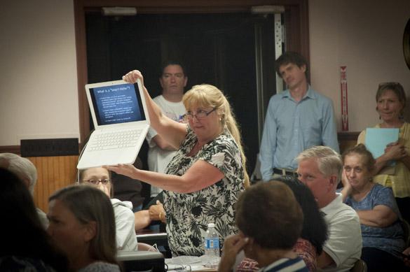 When county Legislator Bob Aiello asked for a definition of “smart meter,” Donna Greco leaped to her feet and held up her laptop (photo by Will Dendis)